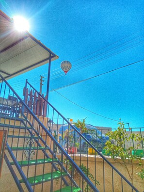 A hot air balloon, a staircase, and a parked car. - Lovely Cappadocia (Ürgüp)