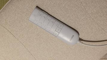 A remote control on a beige couch.
