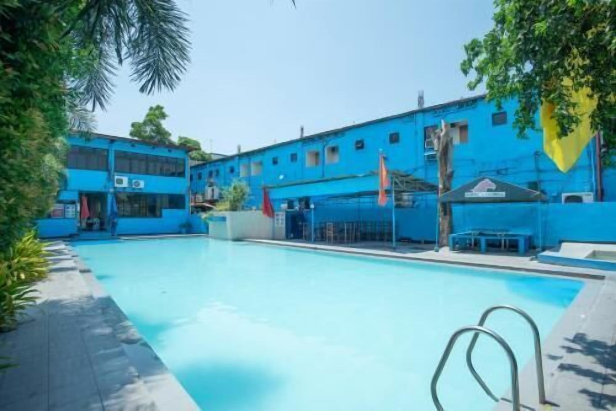 A swimming pool with a blue building in the background.