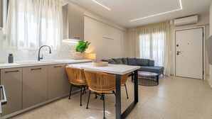 Una cocina moderna con comedor, sofá y una puerta.