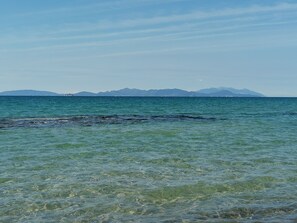A clear view of a coastal area with calm waters and distant mountains. - In the heart of Borgo (Livorno)
