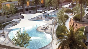 A modern resort with a central swimming pool, lounge areas, and a view of the cityscape. - Bloomfields Vibrant Stu in The Gate (Abu Dhabi)