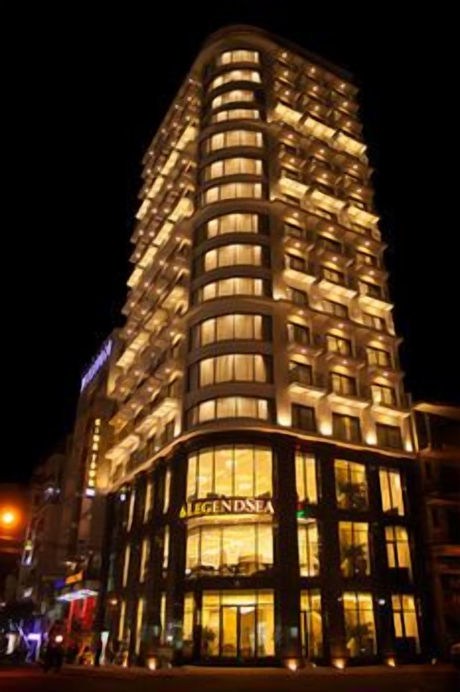 A multi-story hotel with illuminated windows and a prominent sign reading 'LEGENDSEA'.