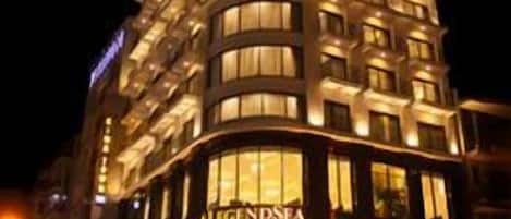 A multi-story hotel with illuminated windows and a prominent sign reading 'LEGENDSEA'.