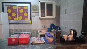 A kitchen with a microwave, stove, sink, and cabinets. There are boxes on the counter and a window with blinds. -  Entire rental, Perfect Abbass el akkad flat with balcony (cairo)
