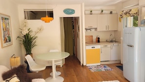 A compact kitchen with white cabinets, a yellow dishwasher, and a white refrigerator. - Exceptional garden level pool cap d'antibes (Antibes)
