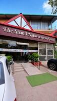 A building with a sign reading 'The Shanti Naturecure on Ganga.'