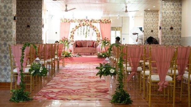 A room with a stage, chairs, and a carpeted floor. - The Shanti Naturecure on Ganga (Rishikesh)