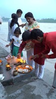 A group of people performing a ritual by a body of water.