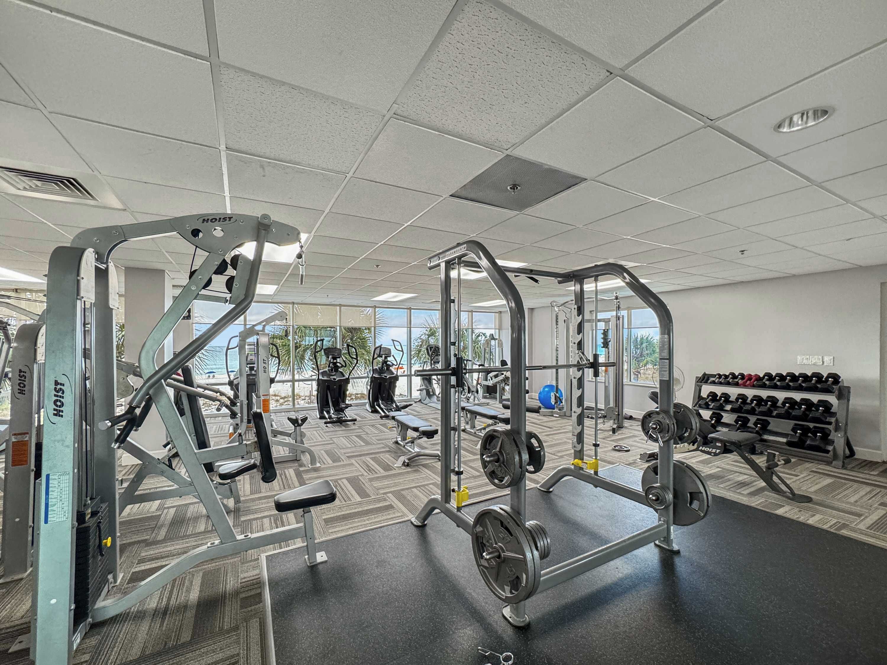 A gym with various exercise equipment, including weight machines and free weights.
