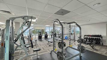 A gym with various exercise equipment, including weight machines and free weights.