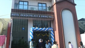 A multi-story building with a sign reading 'HOTEL AKASH PALACE & DINING HALL.' - Hotel Akash Palace  (Kotda Sangani)
