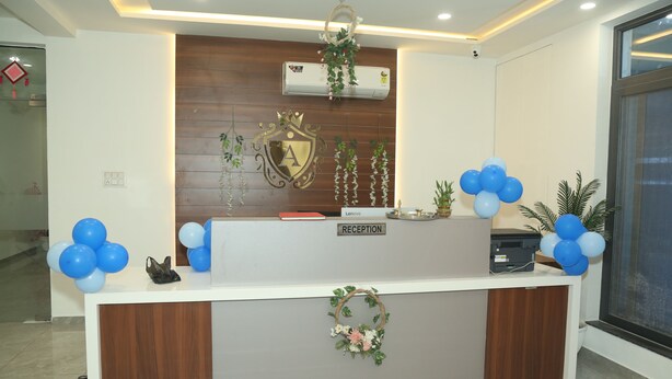 A reception desk with a 'RECEPTION' sign, a wall-mounted air conditioner, and a wooden panel design. - Hotel Akash Palace  (Kotda Sangani)