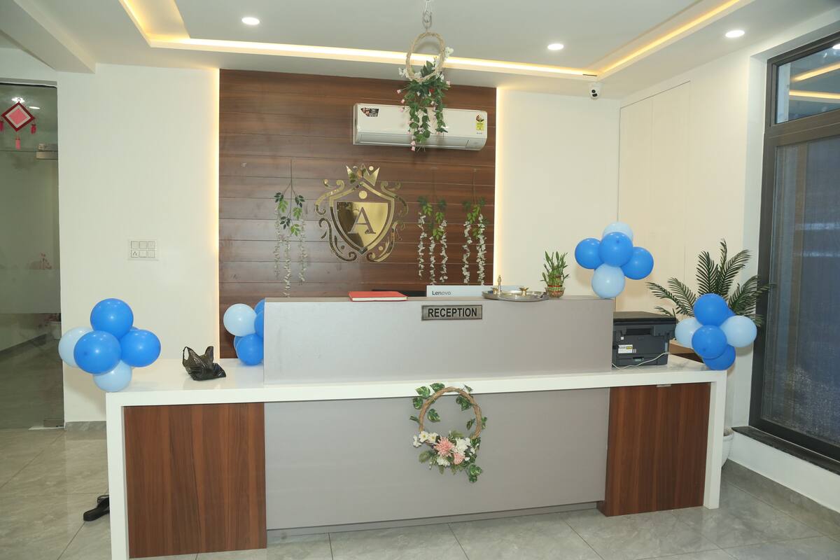 A reception desk with a 'RECEPTION' sign, a wall-mounted air conditioner, and a wooden panel design.