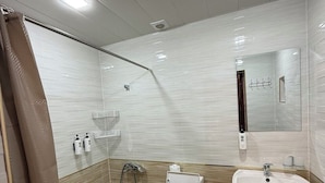 A modern bathroom with a shower, toilet, and sink. - ORIENT HOUSE  (Bukhara)