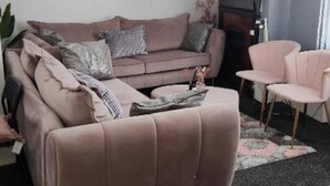 A living room with a sofa, armchairs, and a fireplace. - glamsflat troccadero (Wolverhampton)