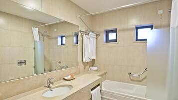 A modern bathroom with a large mirror, a sink, a bathtub, and a shower.