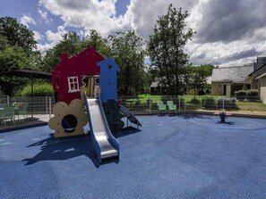 A playground with a slide and climbing structures. - Duplex Cottage With Pool for 4 (Saumur)
