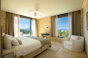 A bedroom with a bed, a desk, a chair, and large windows with curtains. - Messinian Nest (Pylos-Nestoras)
