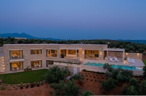 A modern two-story house with a swimming pool, large windows, and a view of the mountains. - Messinian Nest (Pylos-Nestoras)