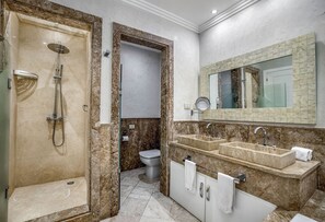 A bathroom with a walk-in shower, a toilet, and a double sink vanity. - Paradise Cove Cap Cana Monthly Rental (La, Altagracia)