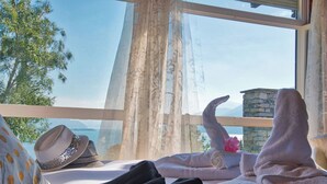 A room with a view of a body of water, a stone wall, and a window with sheer curtains. - Villa Meraviglia  (Olgiasca)