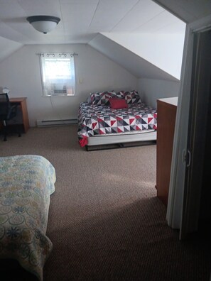 A bedroom with a bed, a desk, and a window. - Charming 3-bedroom house in Ava, NY. (Ava)
