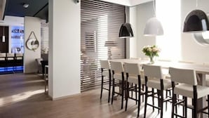 A modern interior with a dining area, a bar, and a kitchen.
