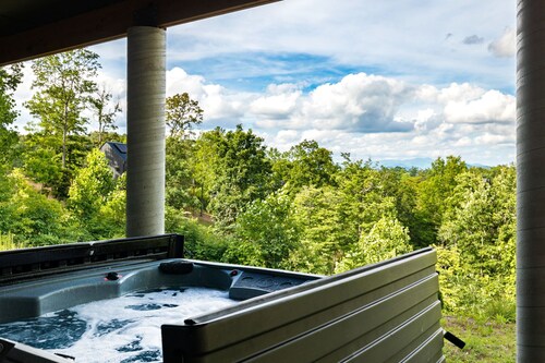 Spacious private mountain retreat featuring a king bedroom with twin bunks, office with futon, full bath, washer/dryer, large kitchenette, and comfortable living area. Relax in your private hot tub, screened porch, and peaceful yard setting.