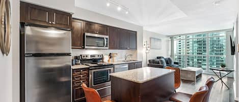 Deluxe Suite, Multiple Beds | Private kitchen