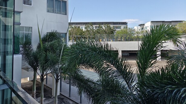 A modern building with a flat roof, large windows, and a view of other buildings in the background. - Rasa Sayang at The Loft Imago (Kota Kinabalu)