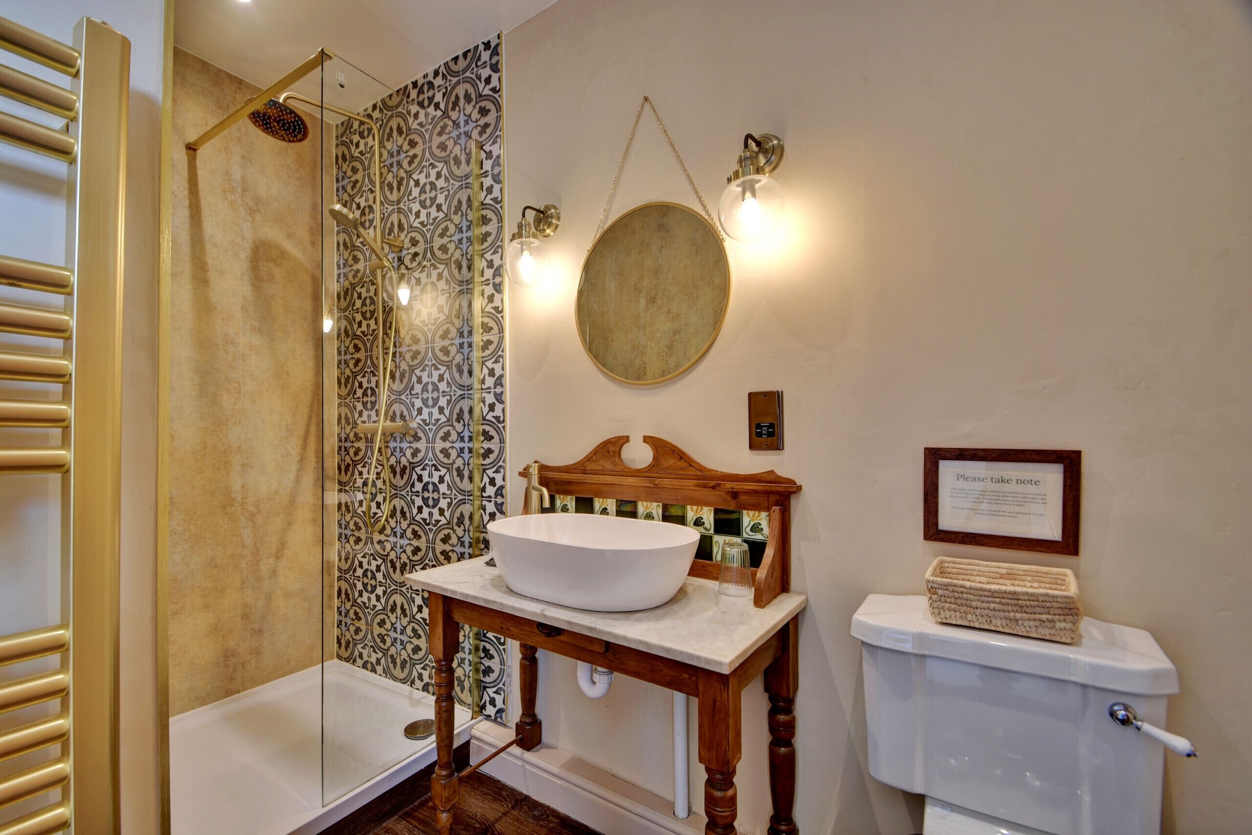A bathroom with a bathtub, a sink with a bowl, a toilet, and a shower.