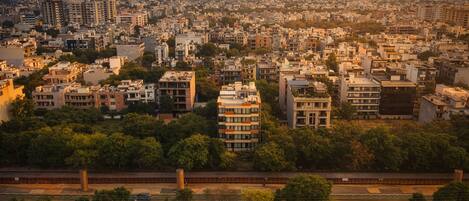 A cityscape with dense urban buildings, a highway, and trees.