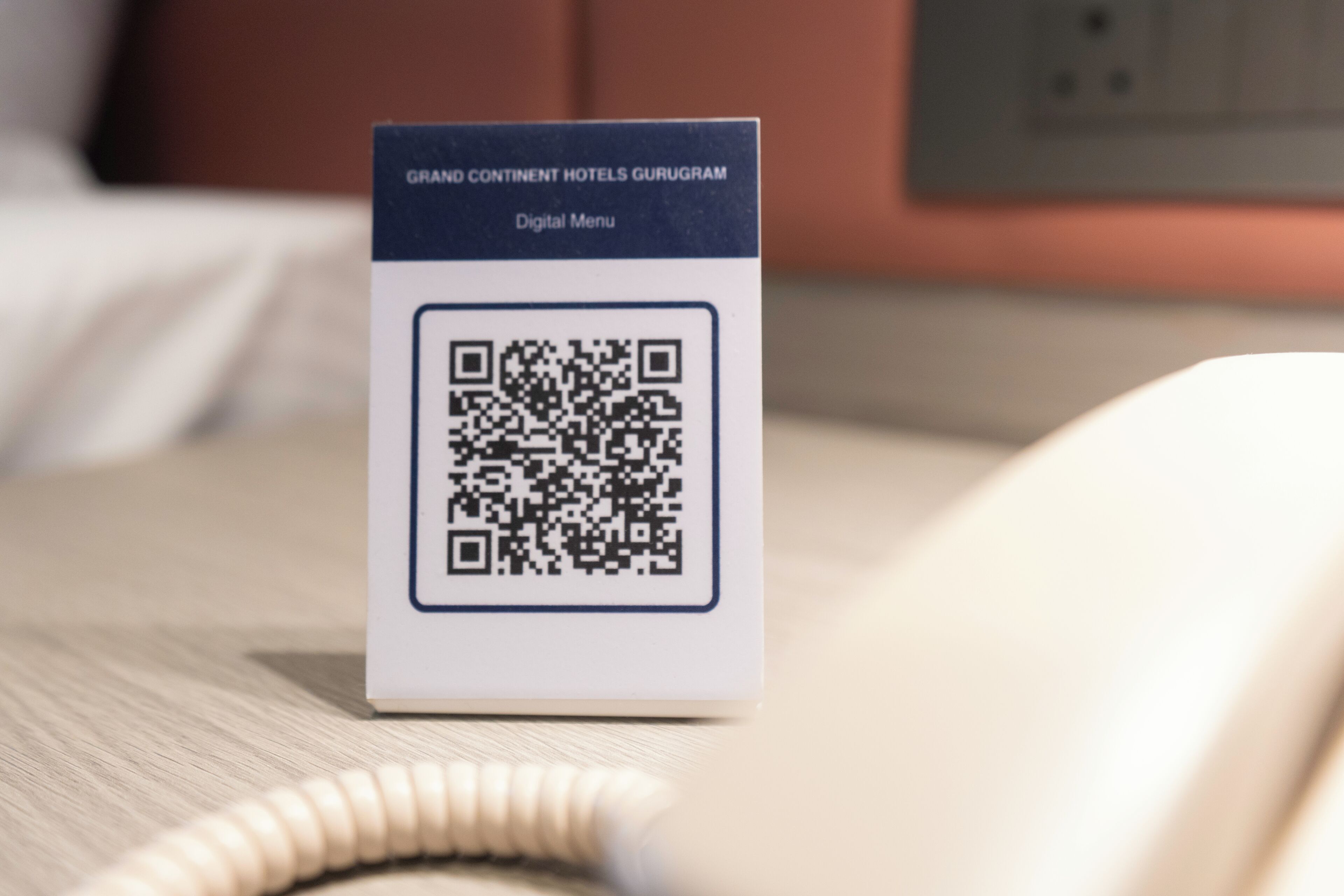 A QR code on a sign with text 'Grand Continental Hotels Gurugram Digital Menu.'