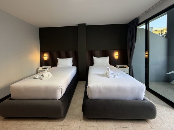 A hotel room with two beds, a large window, and a view of the outside. - Karon Place (Karon)