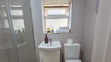 Shower, hair dryer, towels, shampoo