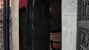 An ornate doorway with intricate carvings, a black door, and a red arch. - Riad Kantarell (Marrakech)