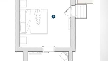 A floor plan of a hotel with a bedroom, bathroom, kitchen, and living area.