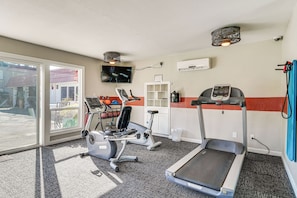 A gym with treadmills, stationary bikes, and a TV screen. - Walkable Pleasanton Condo Near Downtown w/ Balcony (Pleasanton)