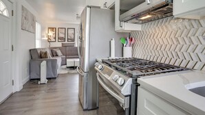 A modern kitchen with a refrigerator, stove, and microwave. - Easy Access to Nyc! Sleek Suburban Apartment (Mamaroneck)