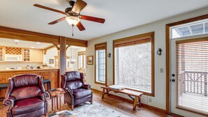 A spacious living area with a ceiling fan, large windows, a fireplace, and a cozy seating arrangement. - Forest-view Balcony & Trail Access! Burnsville Gem (Burnsville)