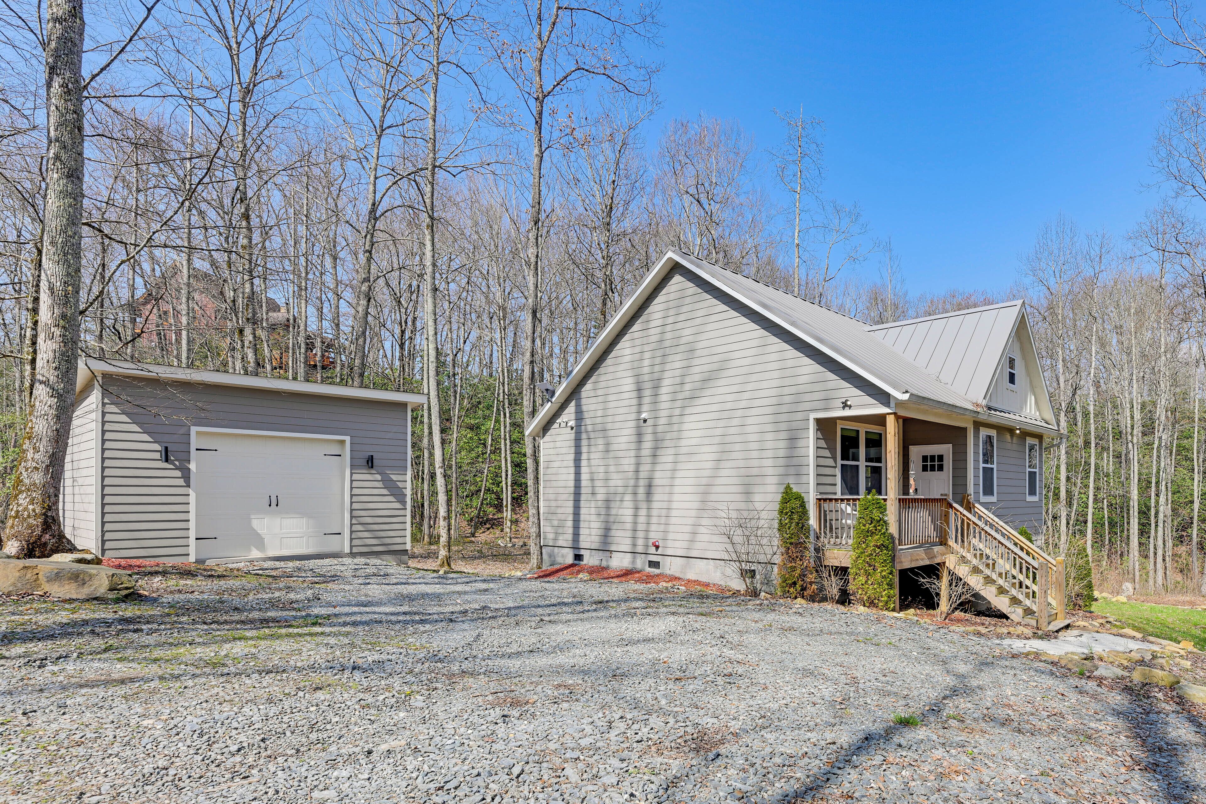 A two-story house with a garage, a front porch, and a staircase leading to the main entrance.