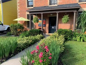 A brick building with a sign for 'Devin's' and 'Airbnb.ca' indicating a short-term rental property.
