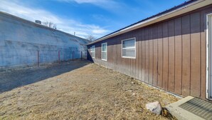 A building with a metal exterior and a wooden section with windows. - Outdoor Adventure Base in the Heart of Miller (Miller)