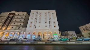 A multi-story building with a central arched entrance, several windows, and a flat roof. - Al Fakhama Aldahbai Al-Shohada (Madinah)