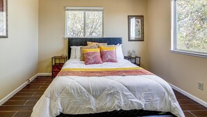 A bedroom with a large bed, a window, and a nightstand. - Wine Country Retreat in Galt w/ Vineyard Views (Galt)