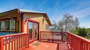 A wooden deck with a red railing, a door, and a window. - Wine Country Retreat in Galt w/ Vineyard Views (Galt)