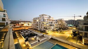 A modern multi-story hotel with a rooftop pool, outdoor seating areas, and a well-lit courtyard. - The Carrousel Residence - Rabat (Rabat)