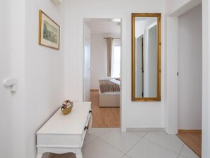 A hallway with a white desk, a framed picture, and a large mirror. - Estate With Sea Views Near Omis (Omis)