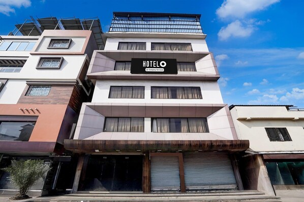 A multi-story hotel with a prominent 'HOTEL' sign, large windows, and a modern architectural design. - Super Itwari Station Formerl Hotel Prime (Nagpur)